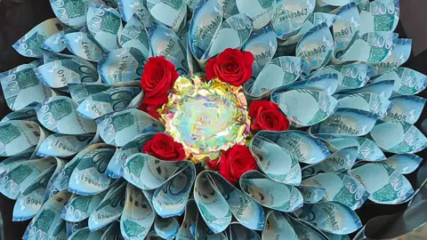 A bouquet made out of blue coloured 200 Kenyan shilling banknotes