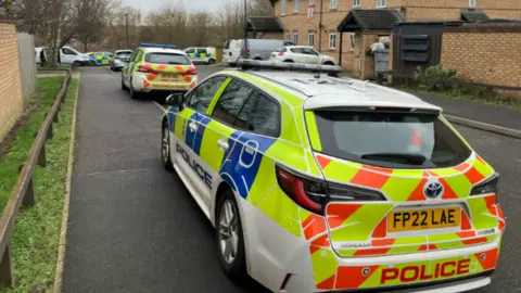 George Torr/BBC Police cars parked in a road