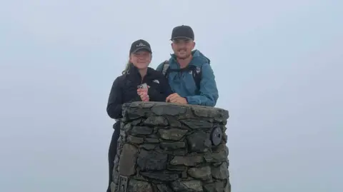 Camping Bible Sarah and Shane on a mountain summit. 