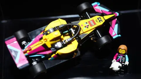 A Lego creation of a Formula 1 car and driver taken from above.
