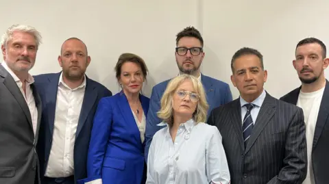 L-R David Webber, Darren Coates, Emma Webber, James Coates, Dr Sinead O'Malley-Kumar (front), Dr Sanjoy Kumar, Lee Coates