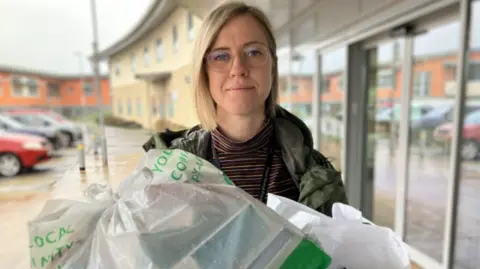 Dr Georgie Kirby is carrying a delivery of waste medicine collected through the 'Show Me Your Meds' campaign. 