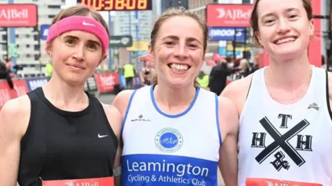 Great Birmingham Run Three women in running gear smiling in at the camera 