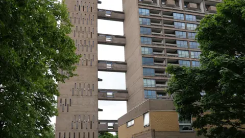 Two brutalist towers linked by concrete bridges