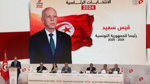 Reuters Farouk Bouasker, President of the Independent High Authority for Elections, announces the preliminary results of Tunisian presidential election in Tunis, Tunisia October 7, 2024.