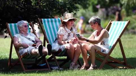 EPA Park goers relax on deckchairs in the shade during a heatwave in London, Britain, 24 June 2026.