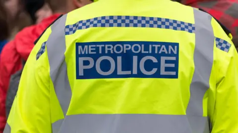 The back of a Metropolitan Police officer's high-vis uniform is pictured.