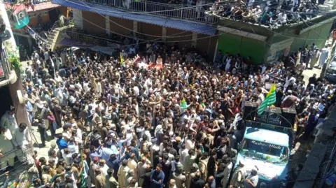 Scores of people gathered at a protest site in Pakistan-administered Kashmir