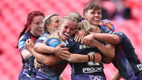Wigan Warriors celebrate scoring against St Helens in the 2025 Women's Challenge Cup final