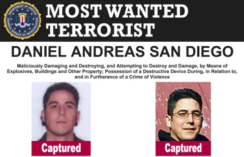 FBI FBI poster announcing that Daniel Andreas San Diego has been caught, featuring two pictures of him, one with glasses, one without, with the word "Captured" beneath each. It also describes the offences he is accused of, including damaging and destroying property