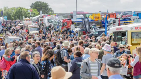 Huge crowds of people throng on a walkway at the Royal Cornwall Show