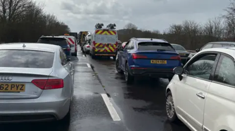 Several vehicles in a queue on the M5 carriageway, southbound, near Exeter