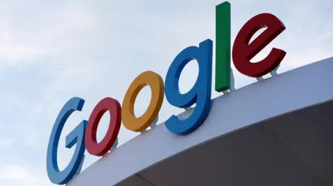 Google's primary-colored logo outside of a building.