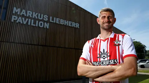 Jack Stephens poses for a photo having signed his new Southampton deal