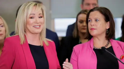 PA Michelle O'Neill pictured smiling beside Mary-Lou McDonald