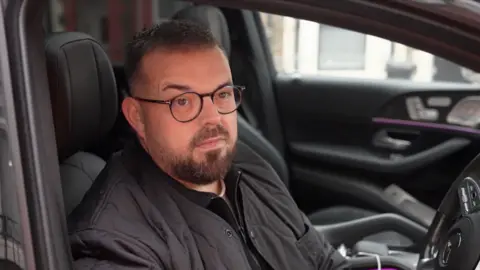 Nic Collins sat in his vehicle 