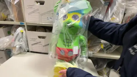 Large green bear figure.