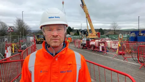 Phototgraph of Andrew Scatchard from National Highways. He is pictured on the construction site of the Mottram Bypass. 