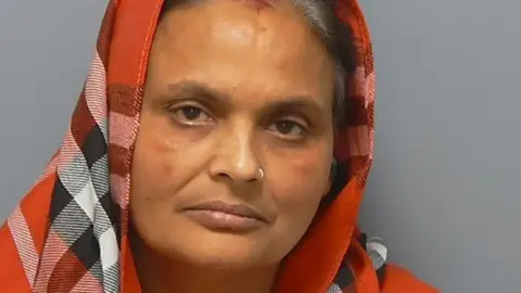 Police handout Kiran Kaur looking at the camera, with a red checked head scarf on on her head.