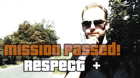 South Norfolk District Council In the middle of the image we can see the words 'mission passed! Respect +' - in the Grand Theft Auto font. Behind that we can a man where a black, short-sleeve shirt with his right hand stroking his chin. He's wearing sunglasses.