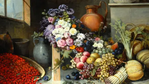 Bowes Museum Oil painting of a still life, with a bunch of flowers, including roses, cornflowers and marigolds, next to a bowl of different coloured grapes and apples. On the bottom right is a basket of redcurrants, and to the left, nestling against the fruit bowl, a bunch of asparagus, three pumpkins or squashes and some celery. In the background are a number of large jugs or vases, and through the corner of a window in the top left can be seen a church steeple.