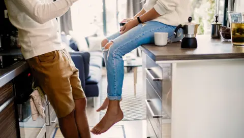 Getty Images A young couple at home in their kitchen