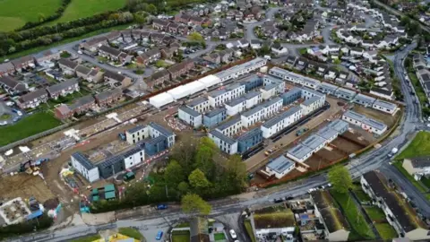 Aerial view of the portable cabins and existing homes surrounding the former school site