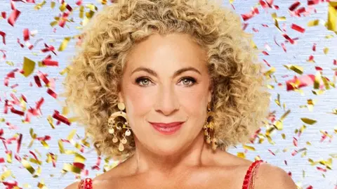 Alex Kingston: Strictly and Doctor Who star reveals womb cancer diagnosis 2 BBC Alex Kingston in tassled red dress with red and gold confetti falling behind her in a Strictly promotional photo