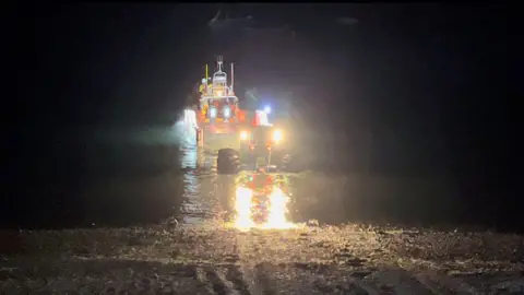 RNLI Jersey RNLI rescue lifeboat in the sea at night