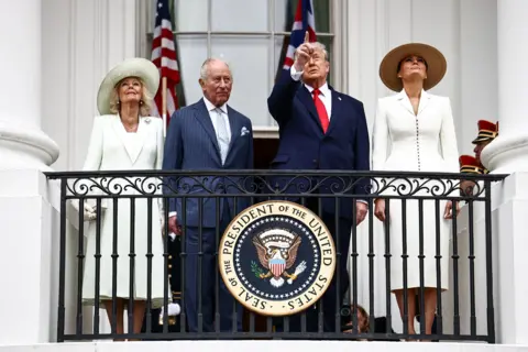 Getty Images US President Donald Trump, first lady Melania Trump, King Charles III and Queen Camilla watch a flyover of military planes from the Blue Room balcony during an arrival ceremony at the White House on day two of the State Visit of King Charles III and Queen Camilla to the United States of America, on April 28, 2026 in Washington, DC