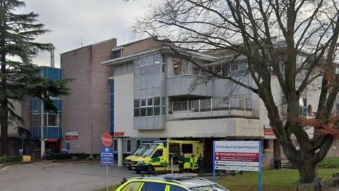 Cheltenham General Hospital with ambulances outside on a winter's day.
