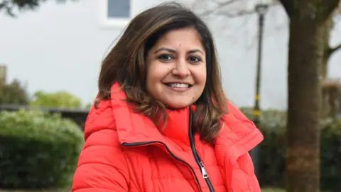 Aditi Banerjee, of Indian jobs agency Magic Billion, wears a bright red coat