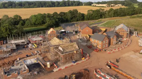 Aerial view looking down on new build housing construction site in England, UK