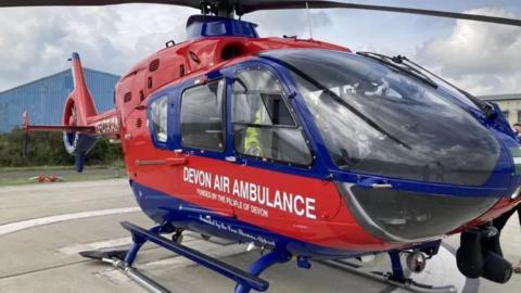 Devon Air Ambulance helicopter on a landing pad