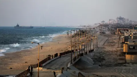 EPA A ship is seen near a temporary floating jetty, on the coast of the Gaza Strip (June 27, 2024)