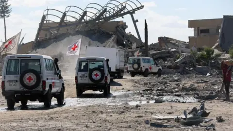 Reuters Red Cross vehicles escort a truck transporting the bodies of Palestinians who had been held in Israel during the war