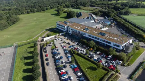 supplied An aerial shot of a school with a large car park and grass fields.