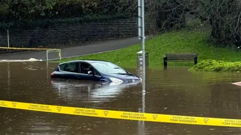 Kelly Jones Cordon around flood water with a vehicle partly submerged