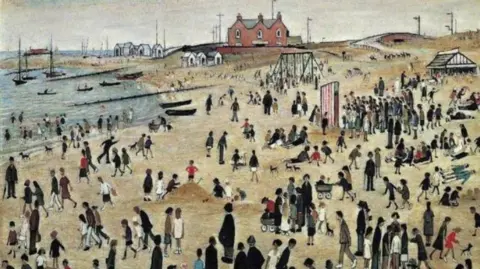 The Estate of LS Lowry/Arts Council Collection  A typical Lowry painting with thin elongated figures many in coats and bowler hats and a dash of red here and there on a beach with swings, beach huts and houses in the distance.