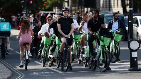 Reuters A line of cyclists waiting at traffic lights