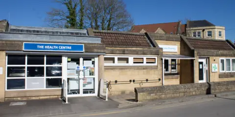 A brick building with a sign which says 'Health Centre'