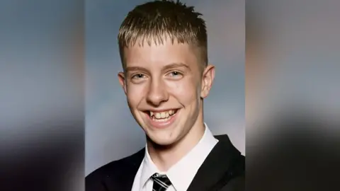 The Chris Cave Foundation A school picture of Chris Cave. A young man, with short brown hair, who is smiling.