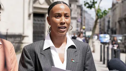 PA Ella Janneh speaking outside the Royal Courts of Justice