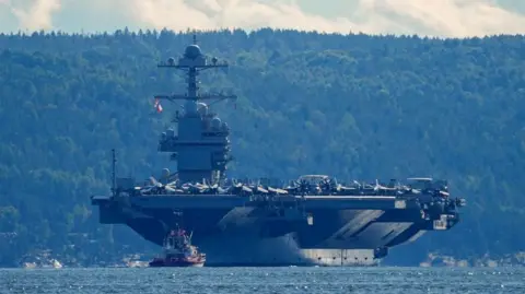 Reuters The world's largest warship, U.S. aircraft carrier USS Gerald R. Ford, on its way out of the Oslofjord at Nesodden and Bygdoy, Norway, September 17, 2025