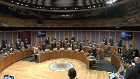 Senedd Cymru Senedd members stand for a minute's silence in memory of Lord Elis-Thomas