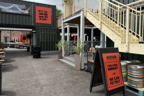 A yard with beer barrels and stairs