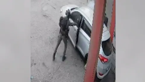 Screengrab of video released by Israeli human rights group B'Tselem showing smoke coming out of a car after an Israeli Border Police officer threw a stun grenade inside, in Qalandia refugee camp, in the occupied West Bank