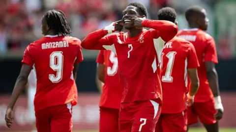 Breel Embolo celebrates with Switzerland team-mates after scoring