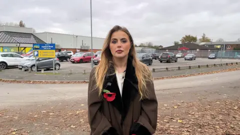 BBC Rosey Hudson standing in front of the car park