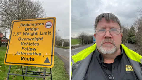 On the left a roadworks sign which reads Baddington Bridge 7.5t weight limit. Overweight vehicles follow alternative route. On the right a man with glasses looking at the camera with a neutral expression. 